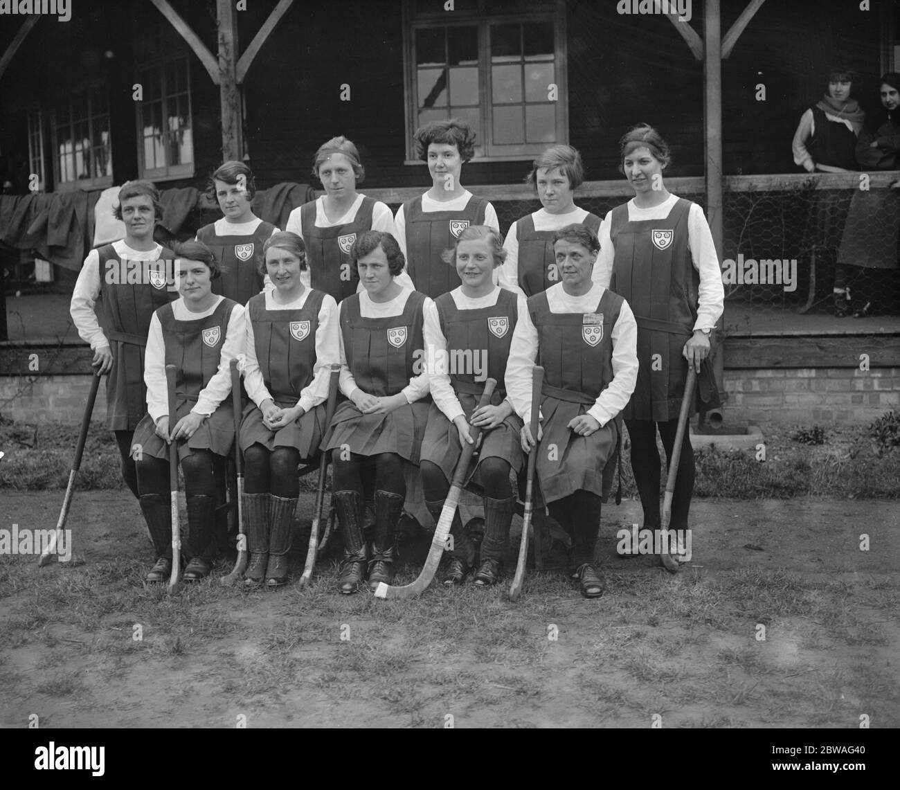 England versus Scotland , ladies hockey at Merton . The English team . Standing left to right - Miss D G Northwood , Miss V Chamberlain , Miss M Pollard , Miss E N Arnold , Miss S Newell and Miss D N Glenday . Sitting left to right - Miss P Scarlett , Mrs Bridge , Miss E Willcock ( Capt ) , Miss K Doman and Miss M Bryant . 16 March 1921 Stock Photo