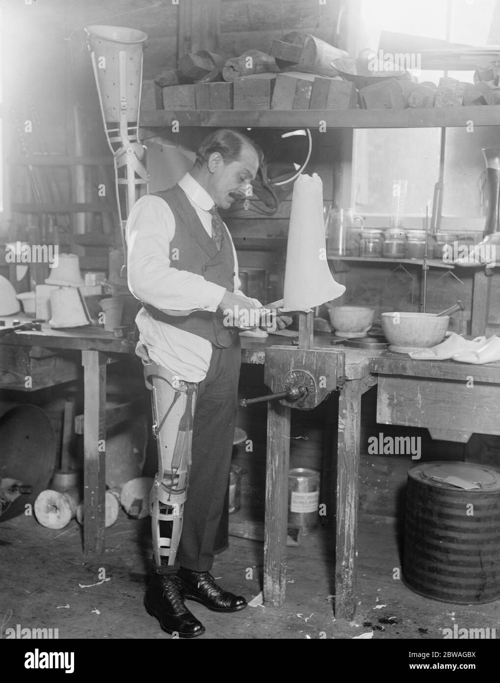 New arms at the Ministry of Pensions artificial limb factory at Thames Ditton A workmen wearing one of the new legs on central thigh socket which are made up of a very light composition 25 October 1920 Stock Photo