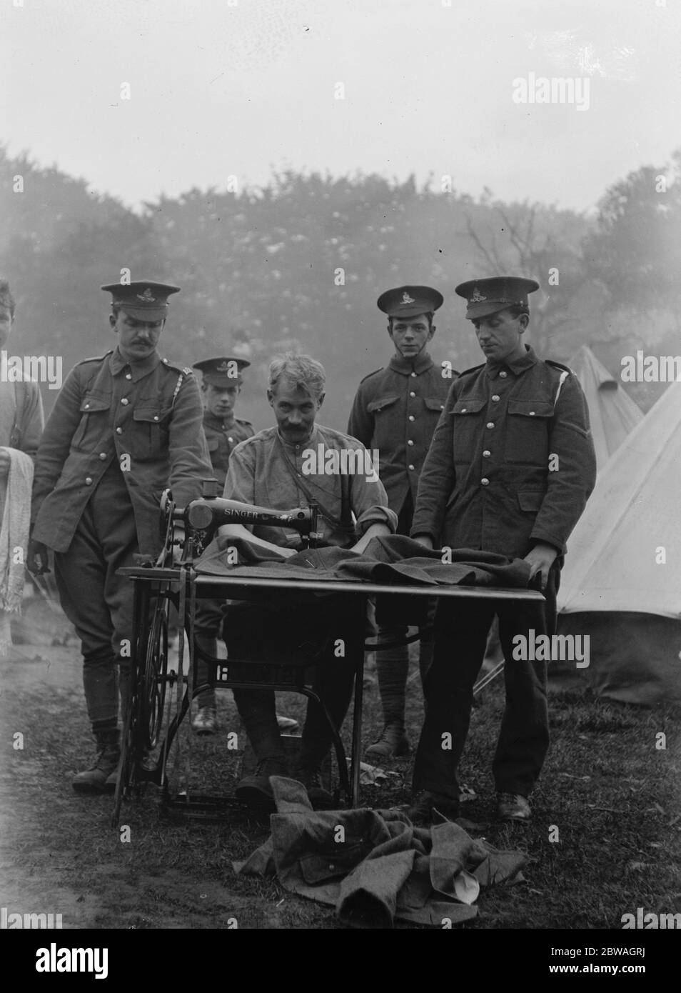 Kitchener ' s Army in Golder ' s Hill park training camp , London . The men getting their uniforms mended by the camp tailor . 1914 - 1918 Stock Photo