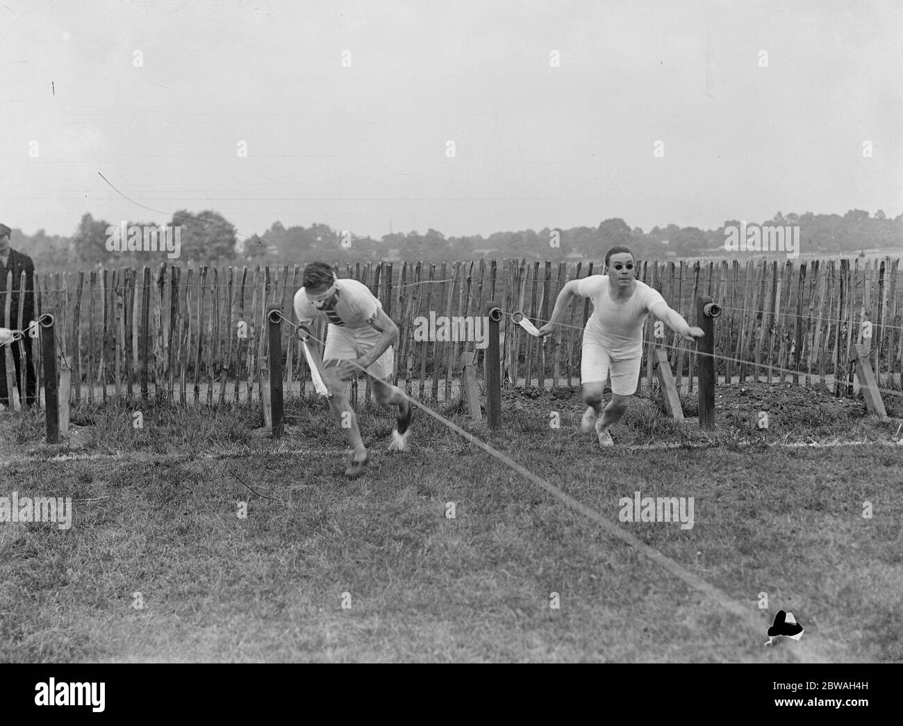 Abrahams , the Cambridge ' Blue ' and 100 yard runner , sprints against a totally blind man at St Dunstan ' s 20 June 1920 Stock Photo