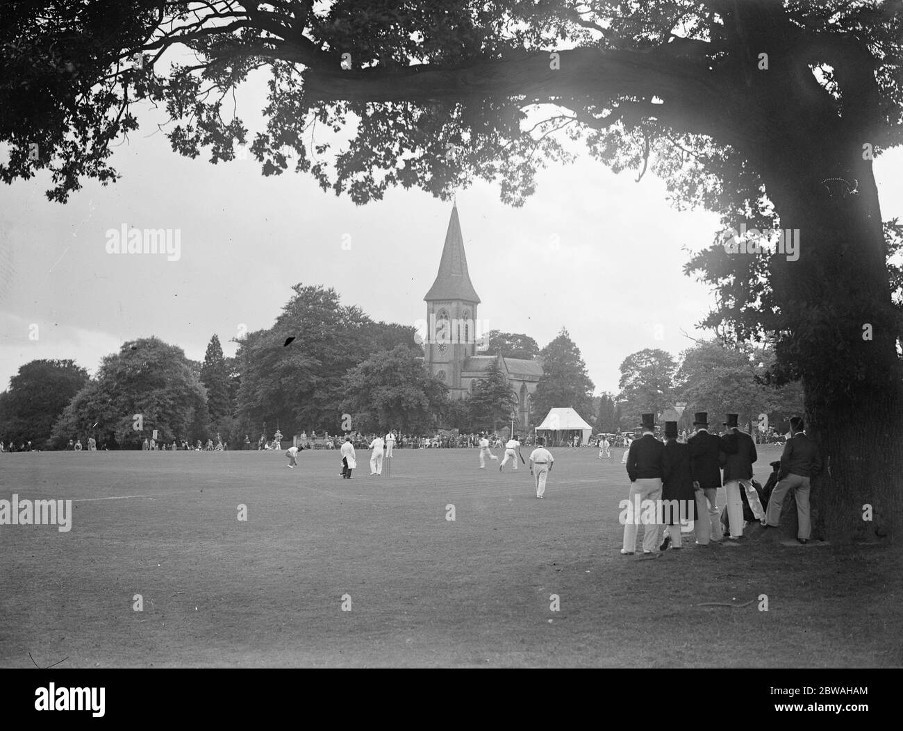 Southborough Church formed a picturesque background to an old time cricket match in which players wore top hats 7 September 1932 Stock Photo