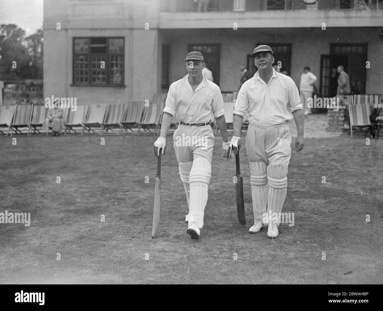 Actors versus musicians cricket at Hampstead Cricket Club Peter Cranmer and Pat Beckett going out to bat for the musicians ( The former is a rugby International ) 27 July 1934 Stock Photo