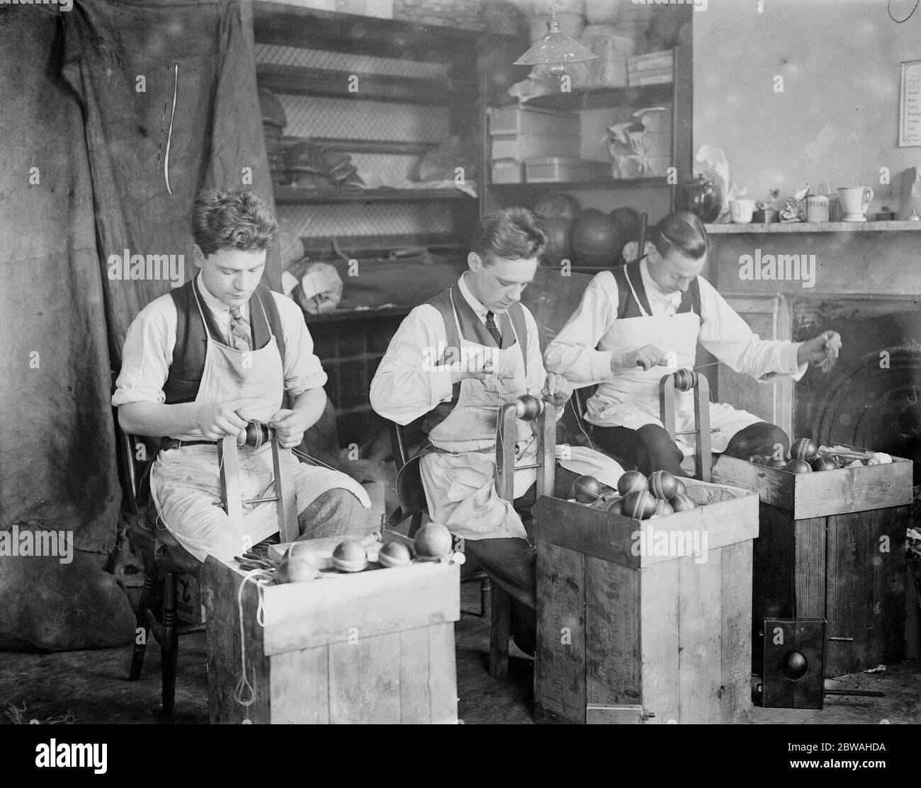 The making of cricket balls at London football company station road , South Norwood Stitching the ball , about 70 to 90 stitches are required , according to the grade of ball 1926 Stock Photo