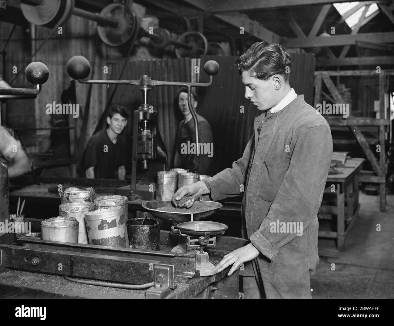 Manufacture of cork balls at Chingford Weighing the compound before