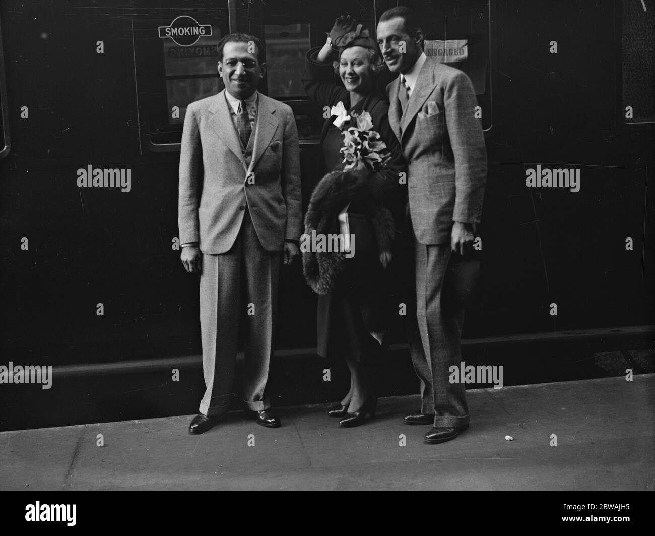 At Victoria . Miss Grace Moore , the prima donna and cinema star . Left to right :- Mr Joseph Friedman ( managing director of Columbia Picture Corporation ) , Miss Grace Moore and Mr Valentine Perara ( her husband ) . 17 June 1935 Stock Photo