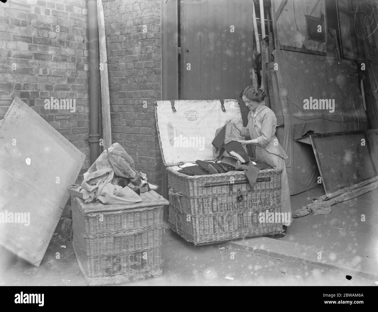 Touring companies prepare for the provinces Packing costumes in property baskets Theatrical Basket property manufacturer A Cook Waterloo Bridge London Stock Photo