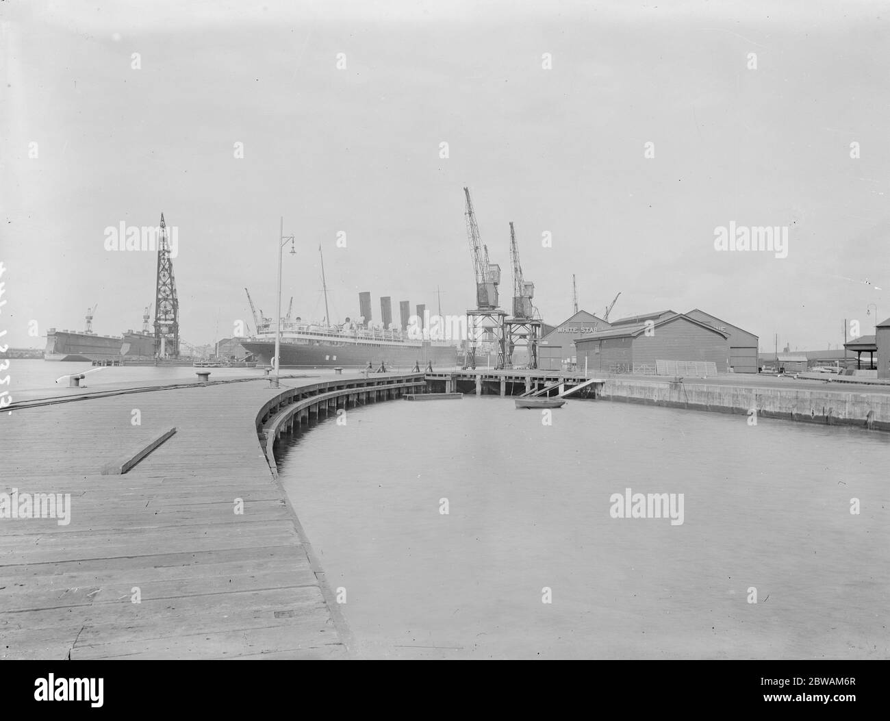In the Southampton harbour with the White Star sheds and Cunard Line Sheds . The RMS Mauretania lies in wait Stock Photo