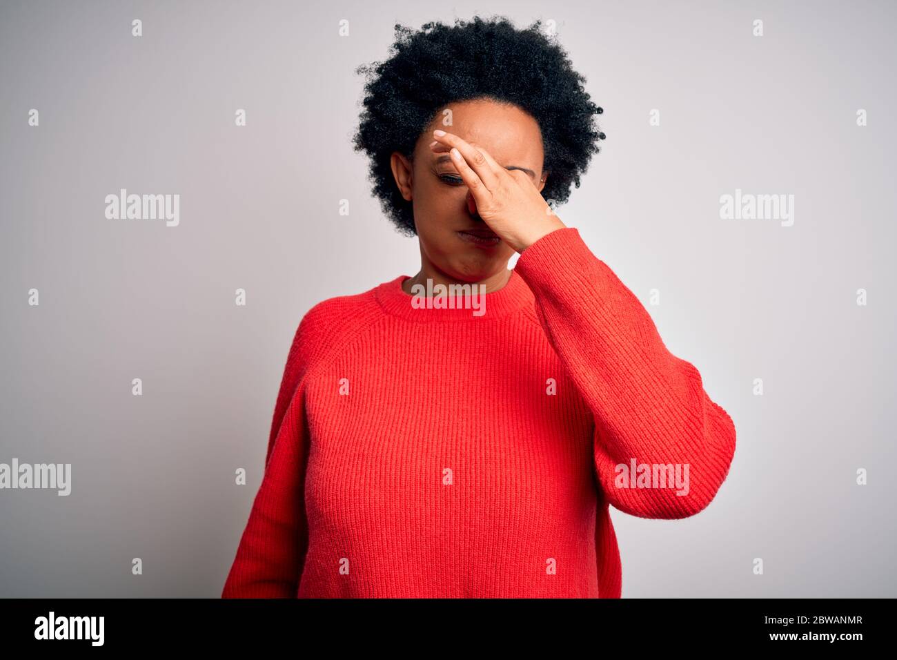 Young beautiful African American afro woman with curly hair wearing red ...