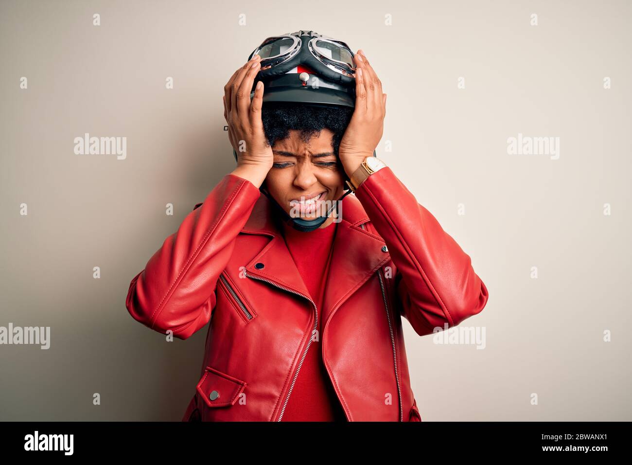 Young African American afro motorcyclist woman with curly hair wearing