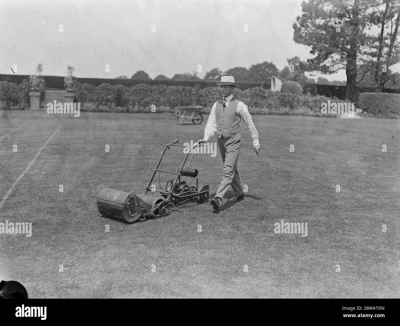 Mr Frank Rendle and his motor lawn mower ( it is not known if this is actually Frank Rendle) Stock Photo