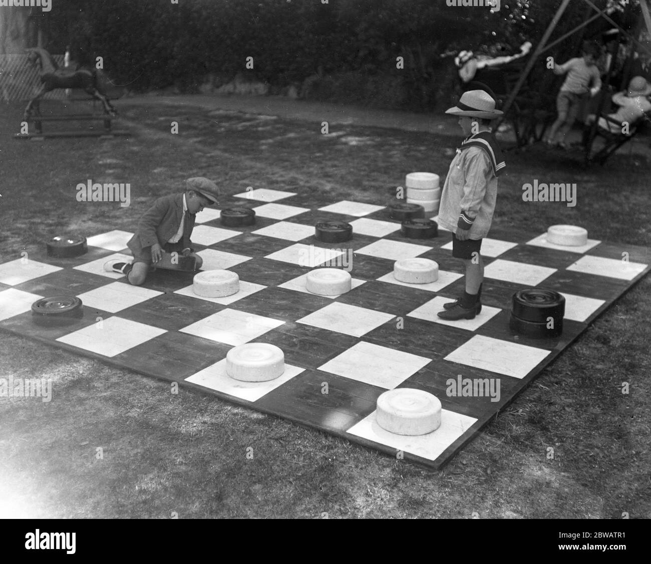 Children play giant draughts in Devonshire Park , Eastbourne , Sussex . 21 June 1920 Stock Photo