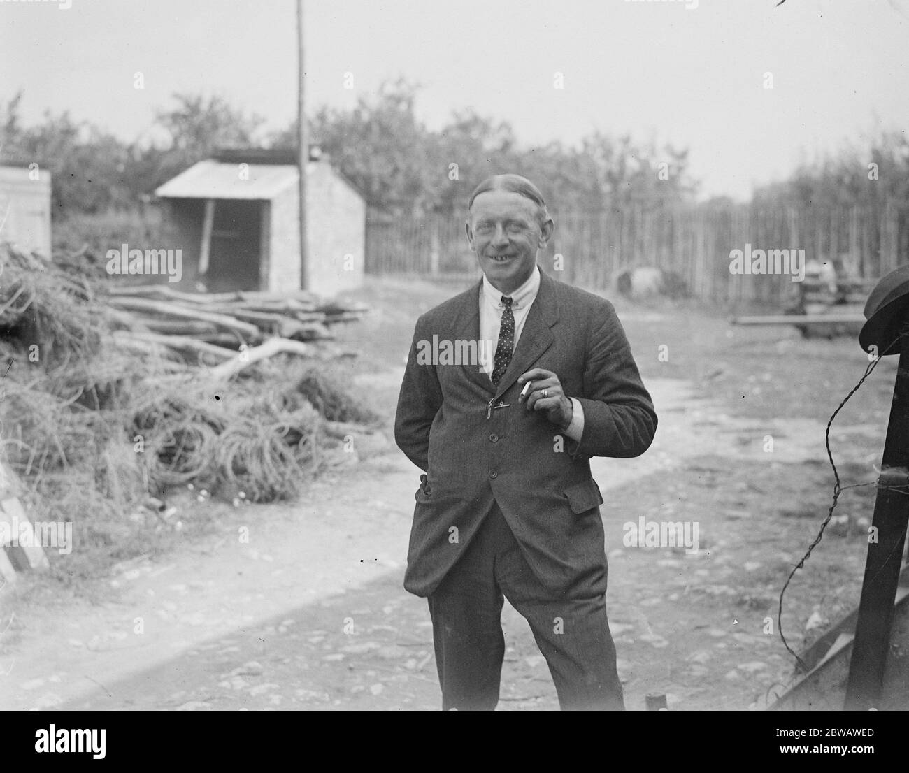 Mr E F Chambers who has installed on his farm at Wellington Place , Otham Kent the E Clemns Horse Hop picking machine 6 September 1921 Stock Photo