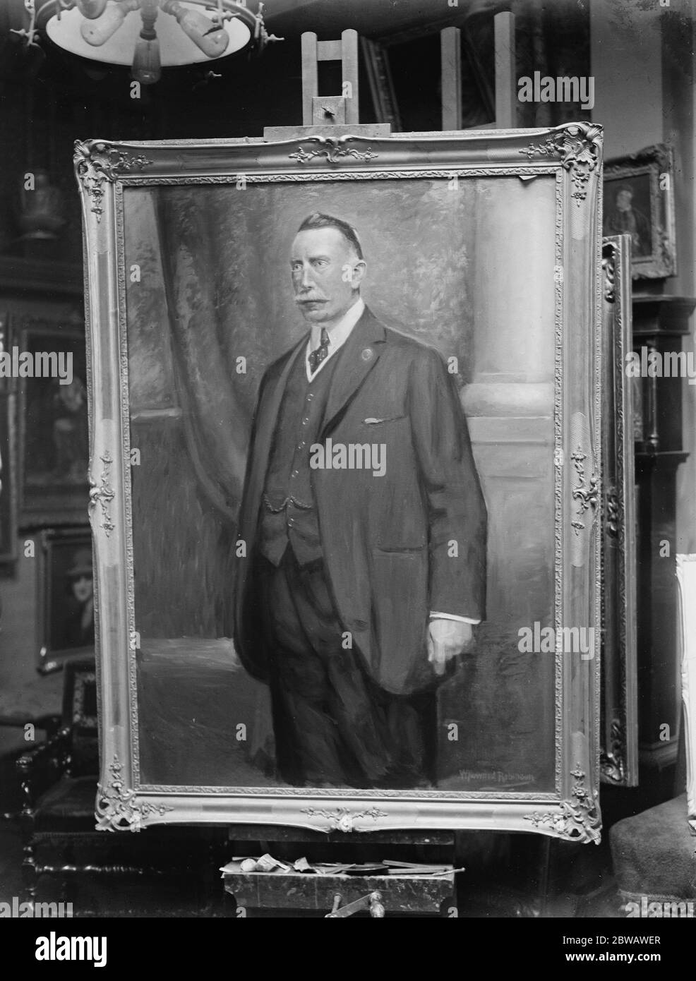 Premier of Northern Ireland sits for his portrait The picture of Sir James Craig as executed by Mr Howard Robinson 15 December 1921 Stock Photo