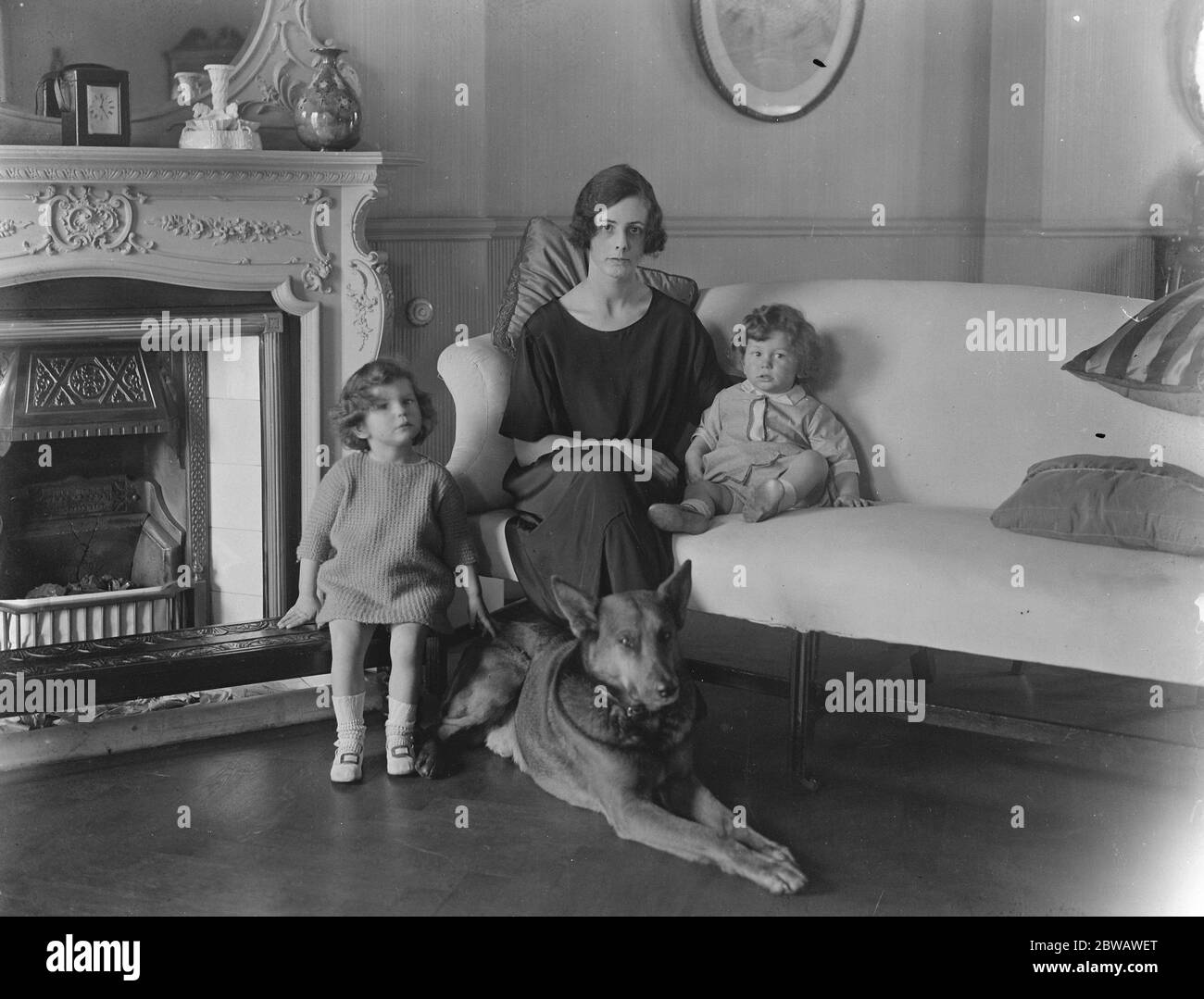 Earls Grandchildren with their big pet Wolf Lady Evelyn Graham , daughter of the Earl of Lovelace , her two year old daughter ' Sheila ' ( on right ) and her little son Clyde , photographed at home in London with their big pet alsatian hound ' Wolf ' 13 April 1922 Stock Photo