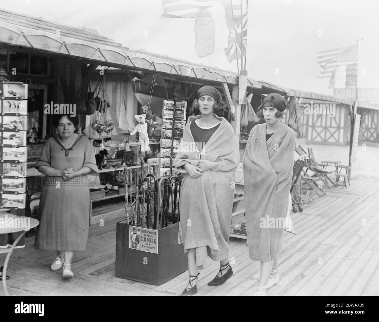 The Deauville Season . Miss Paula Gellibrand , one of the most beautiful women in Society on her way to bathe with the Baroness de Erlanger 's daughter ( right ) . 13 August 1921 Stock Photo