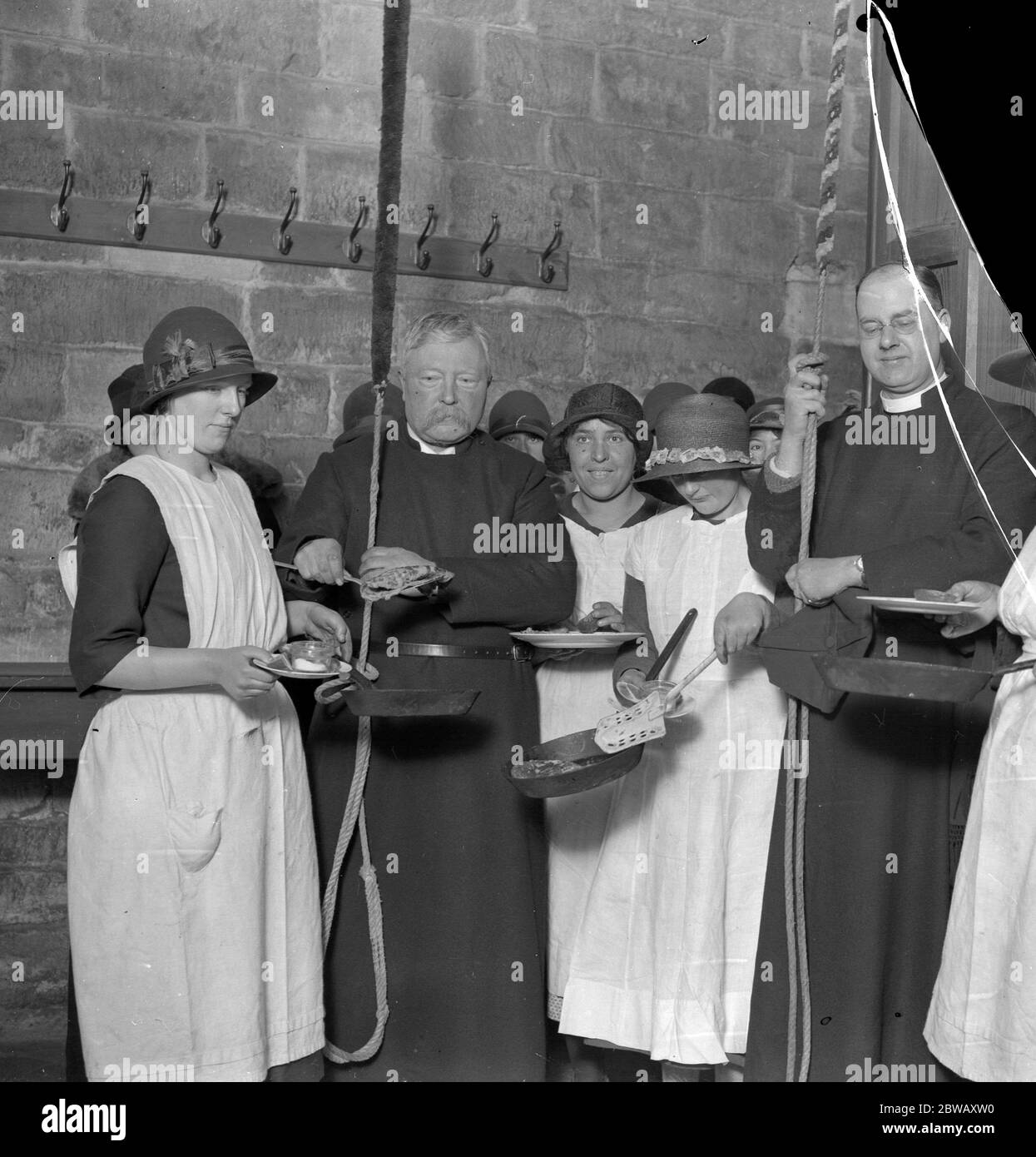 A quaint custom is observed on Shrove Tuesday at Olney Church , Buckinghamshire , when pancake bells are rung from the belfry for the  birth  and  death  of the pancake . Photo shows bellringers about to partake of the pancakes . 16 February 1926 Stock Photo