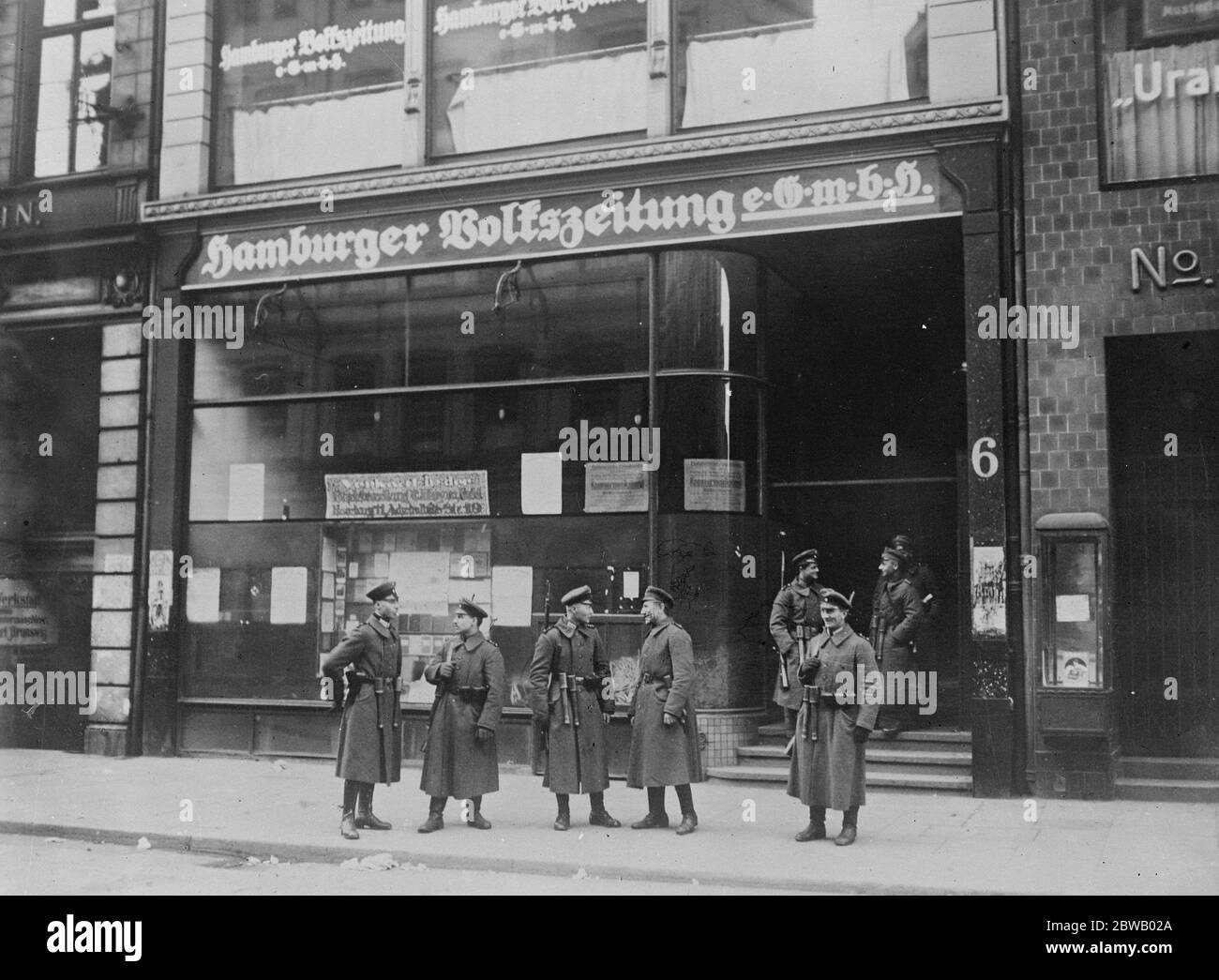 The Communist Outbreak in Industrial Germany The Communist rising in the industrial centres of Germany has been met with stern measures , among which are barbed wire entanglements and machine guns . The office of the Hamburg Communist paper occupied by the security police 29 May 1921 Stock Photo