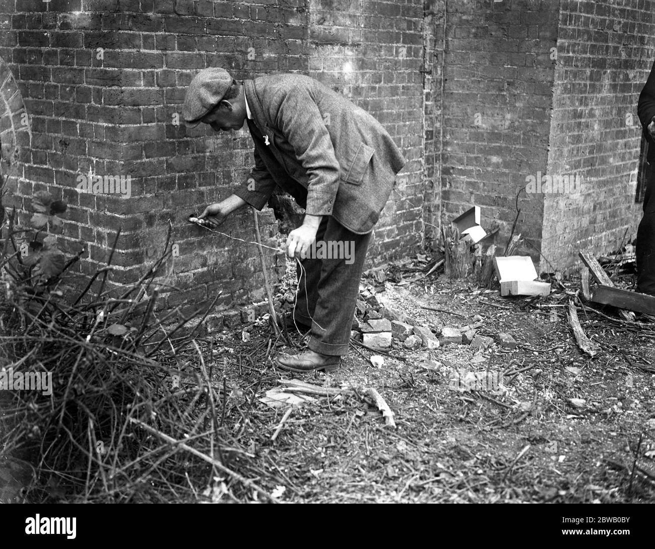 Chimney felling by gelignite at Bedfont Powder Mills , Hounslow . Putting in a gelignite cartridge with detonator at the base . 26 June 1921 Stock Photo