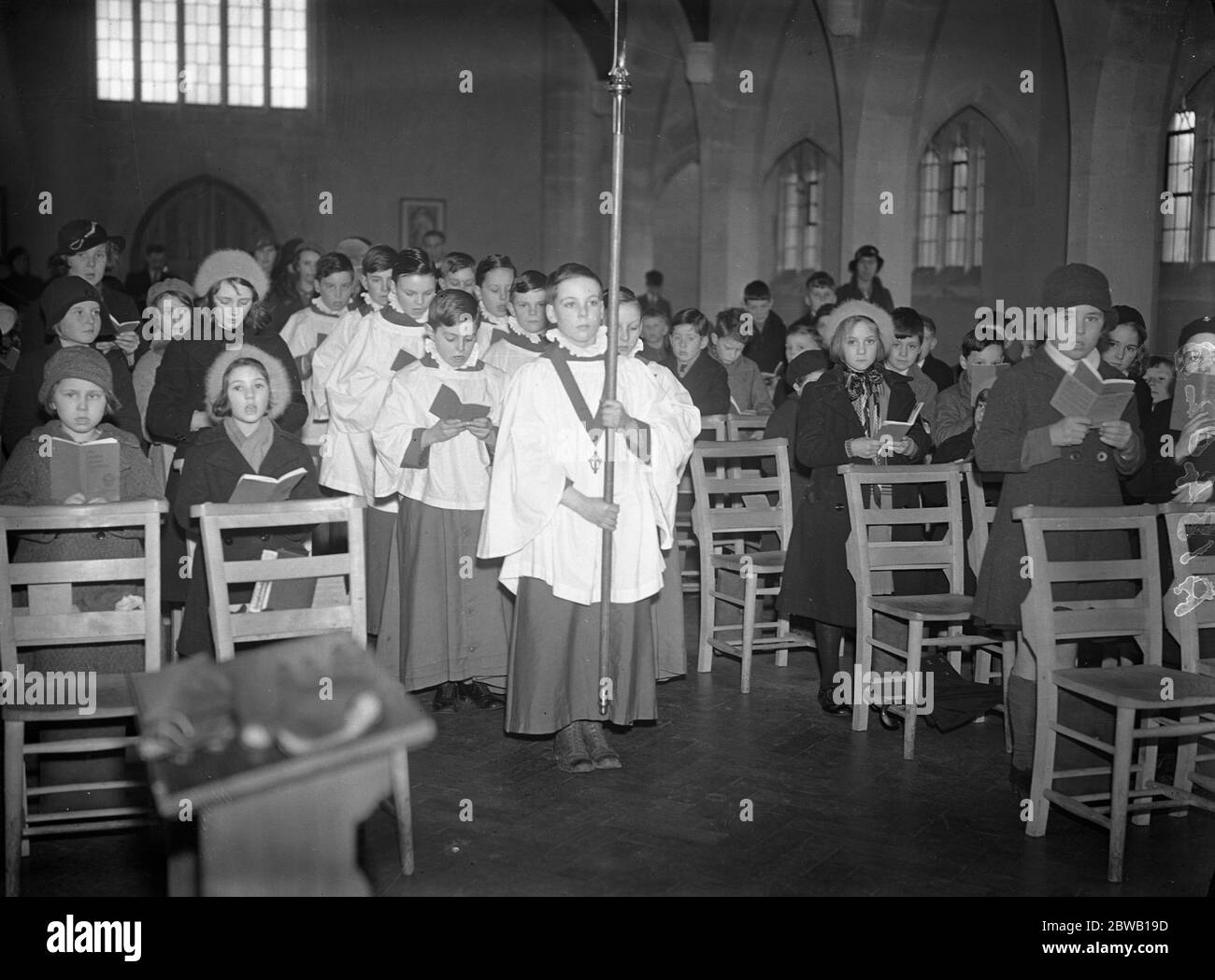 Once a month a children ' s service is conducted by the small worshippers themselves . It is held at St Paul ' s Church , Egham Hythe , Surrey . The vicar and sidesmen being elected by themselves . The procession into the church . 1 March 1936 Stock Photo