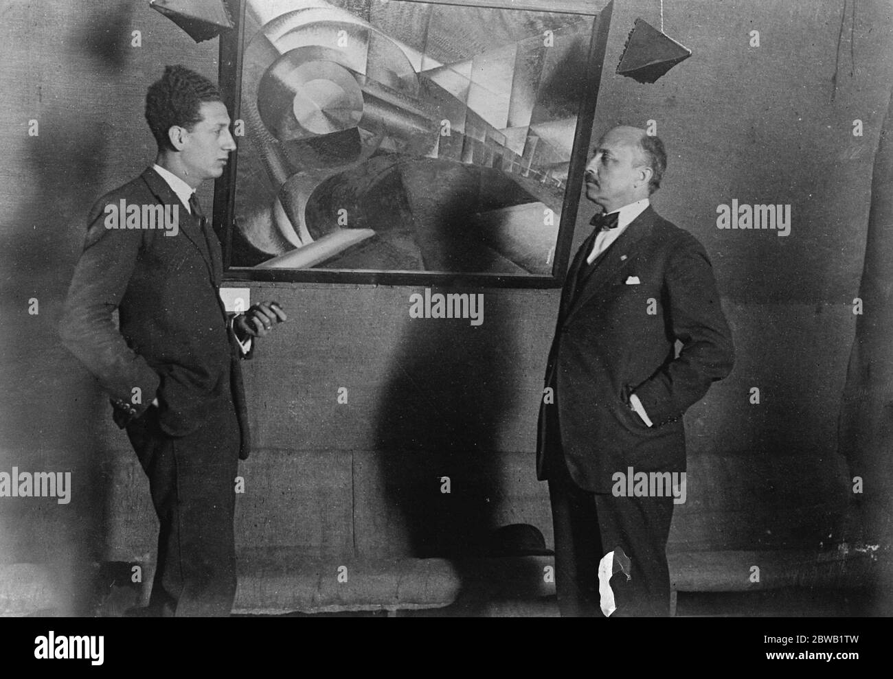 Futurist Art Leader At a Futurist Art Exhibition in Rome A new exhibition of futurist 's work has been opened at Rome . On right is seen Signor Marinette the futuristi art leader standing before a a painting entitled ' The Train ' 27 Jauary 1923 Stock Photo