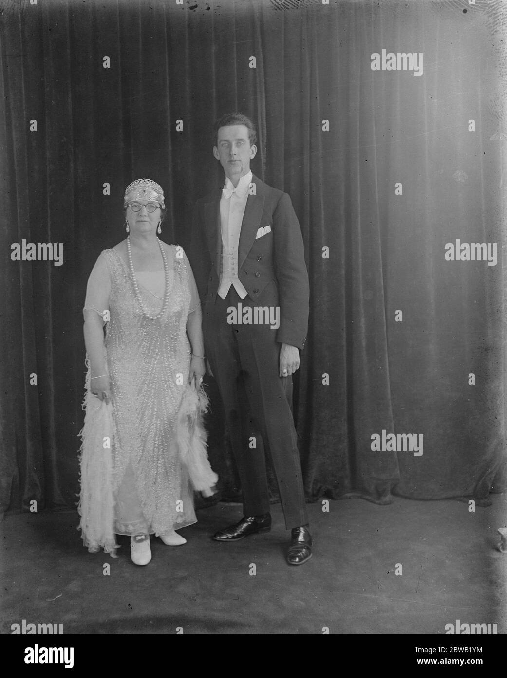 Society and stage at Devonshire House Ball in aid of the People 's League of Health . Mrs Smith Wilkinson , famous for her wonderful dresses , and her husband . 26 November 1921 Stock Photo