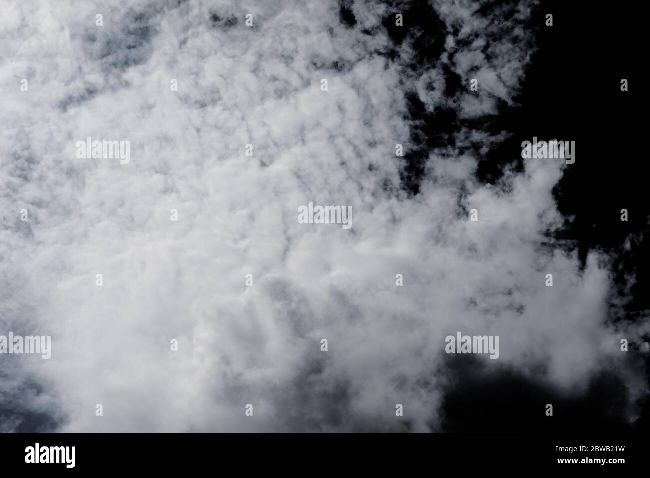 White clouds on isolated black sky. Panorama view background or overlay elements for design projects Stock Photo