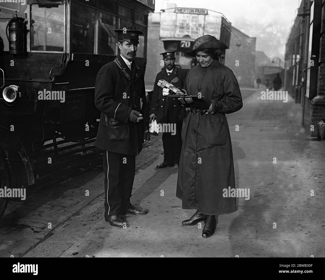 A woman bus inspector checking time boards etc . 4 December 1916 Stock Photo