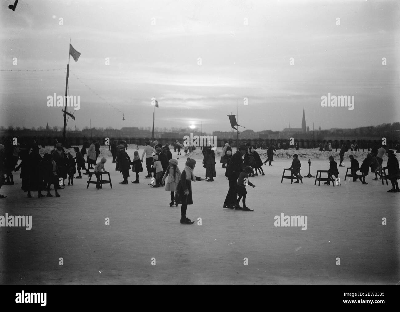 Sunset over the frozen waterways of Holland , crowded with happy skaters 4 December 1921 Stock Photo