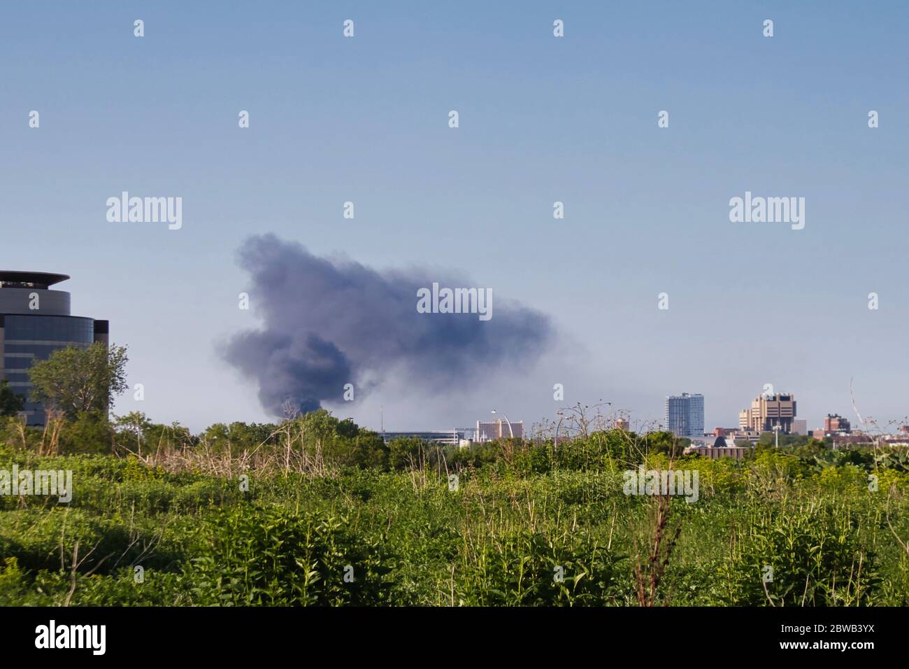 Smoke rising from South Minneapolis after rioting. George Floyd protests. View from Ridgway Parkway. Stock Photo