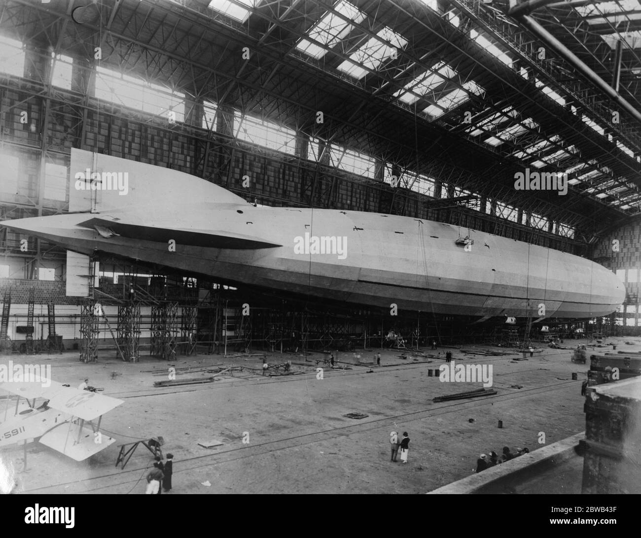 Great American airship about to make its trial flight . The great American airship ZR1 , which has been completed at Lakehurst , New Jersey , is expected to make its trial flight this weekend . An aeroplane contrasted with the airship . 30 August 1923 Stock Photo