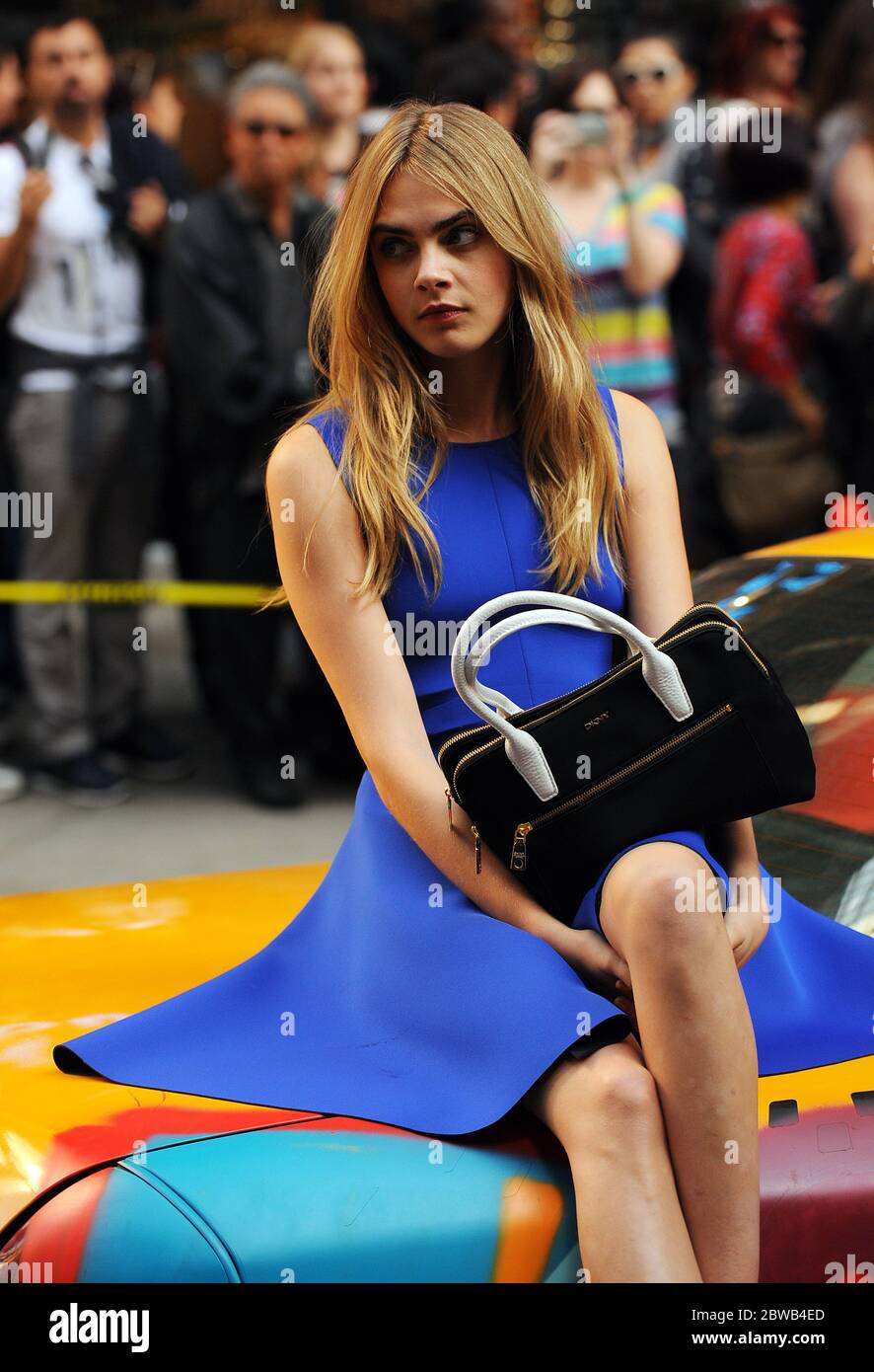 cara delevingne blue dress Cara Delevingne chows down on a greasy McDonald's meal on DKNY shoot
