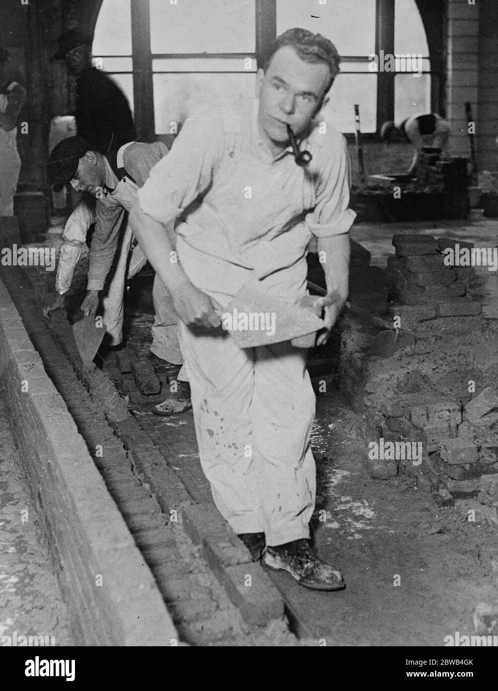 Brick laying To Win A Bride A J H Taylor , former captain in the British Air Service , is now laying bricks in New York City , after running through a fortune , in order to win the love of an aristrocratic English girl and prove his worth . He is shown here learning his trade 23 May 1924 Stock Photo