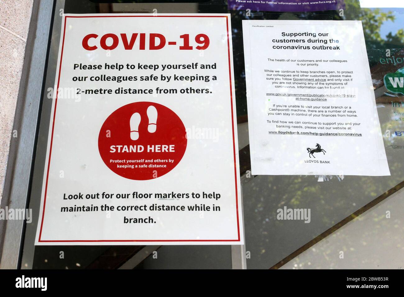 A social-distancing sign in the window of the Lloyds Bank in Braintree ...