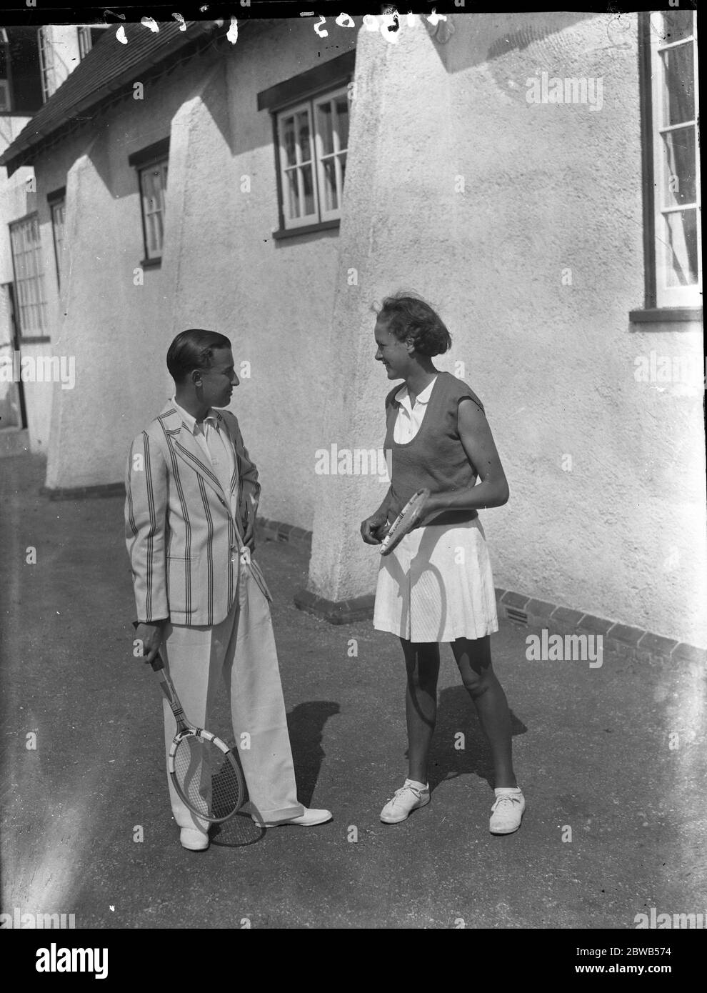 At the Brockenhurst Junior Tennis Tournament , Master Derek Hardwick ( brother of Mary Hardwick ) and Miss Katherine Tuckey ( sister of Raymond , Davis Cup player ) . 1937 Stock Photo