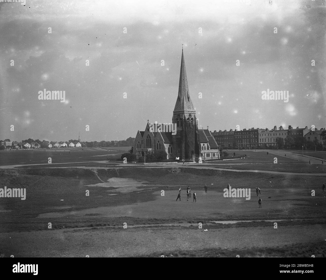 Blackheath , London , showing the Heath and All Saints Church with a cricket match on the heath . Stock Photo