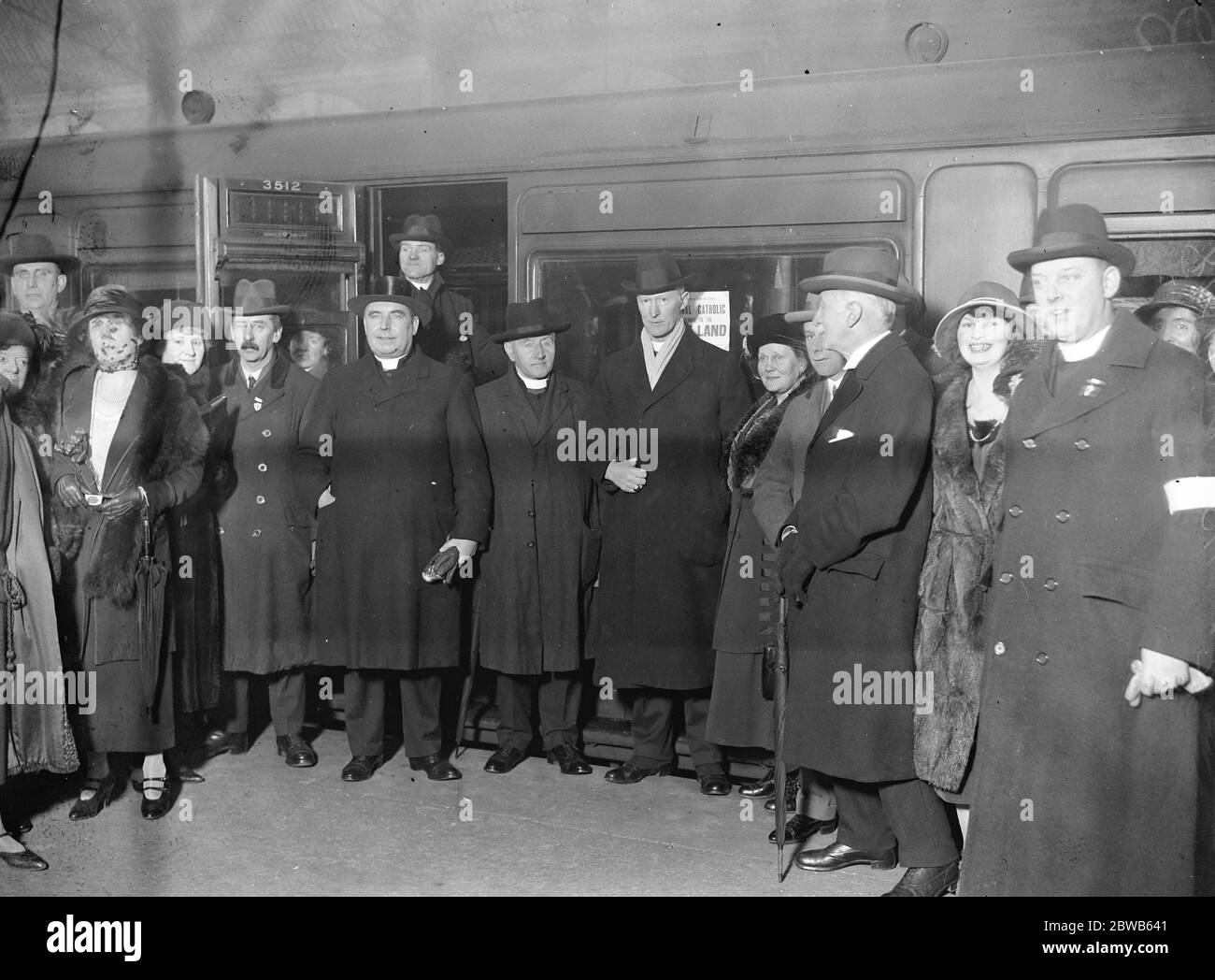 Cardinal heads pilgrimage to the Holy Land . The national pilgrimage to the Holy Land by the Catholic Association , which is to be under the leadership of Cardinal Bourne , left London . Left to right : The Bishop of Brentwood and Bishop Shine in the centre of the group of pilgrims at Victoria Station . 19 February 1924 Stock Photo