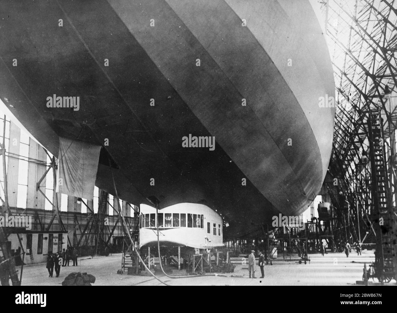 First photos of Zeppelin which will attempt to cross the Atlantic . Photo shows the complete ZR3 , the giant commercial zeppelin built for America at Friedrichshafen . This zeppelin which is constructed along semi - rigid lines will be used for commercial purposes . It is fitted with twenty sleeping compartments and has facilities for cooking and a heating plant for the comfort of the passengers . 26 August 1924 Stock Photo