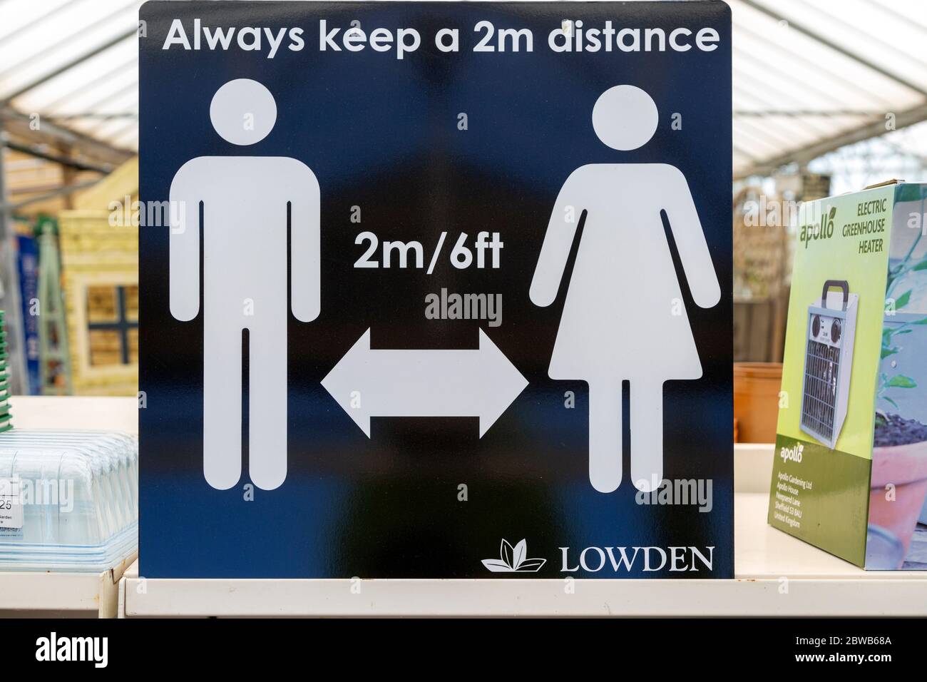 Social Distancing 2 metres apart information notice sign in Lowden garden centre shop, Wiltshire, England, UK, May 2020 Stock Photo
