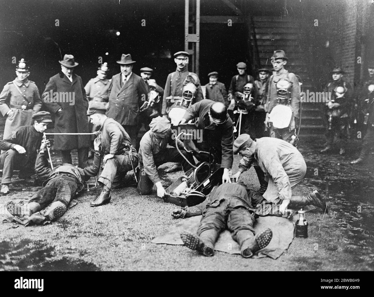 After the great German mine disaster . Scenes at the pithead after the disaster at Heinitz Mine , in Upper Silesia . Experts are seen at work attempting to revive ' gassed ' men by means of oxygen and artificial respiration . It will be noticed that , on the left , an ingenious device is being used to facilitate artificial respiration . 6 February 1923 Stock Photo