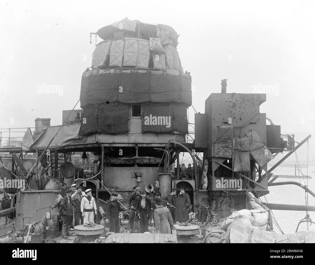 The Great Naval raid on Zeebrugge . Crewman aboard HMS Vindictive a British protected cruiser . On 23 April , 1918 she was in fierce action at Zeebrugge when she went alongside the Mole and her upperworks were badly damaged . British sailors , survivors of the raid , on the upper deck , showing some of the damage . 1918 Stock Photo