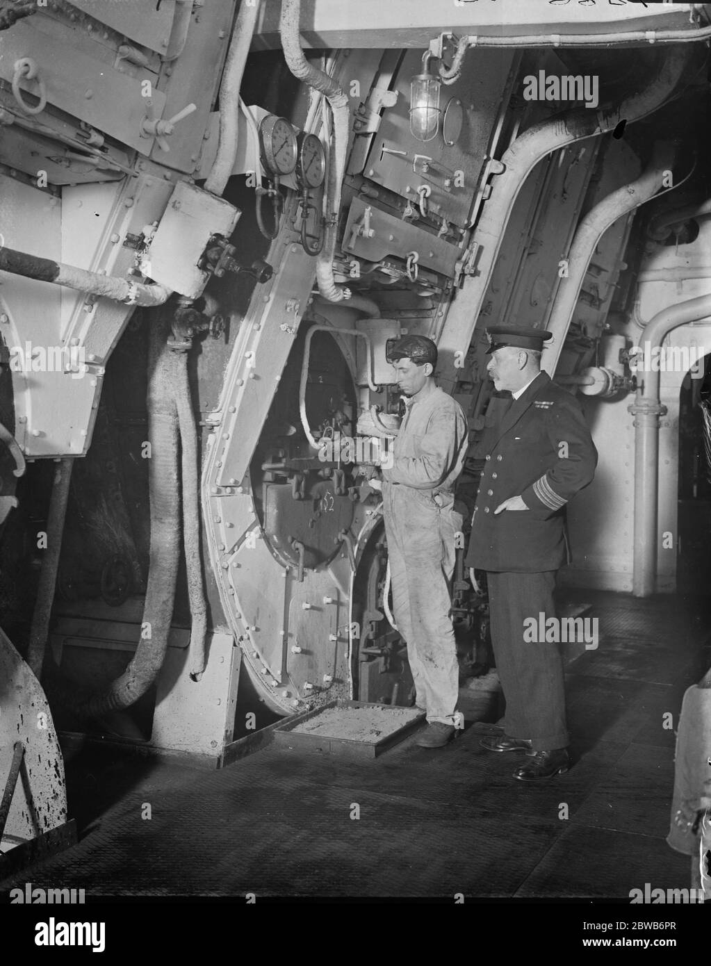The latest Oil Burning Liner . The White Star liner , ' SS Homeric ' , was inspected at Southampton docks after her conversion into an oil burning liner . Here the chief engineer can be seen training crewman how to direct oil spray . 24 April 1924 Stock Photo