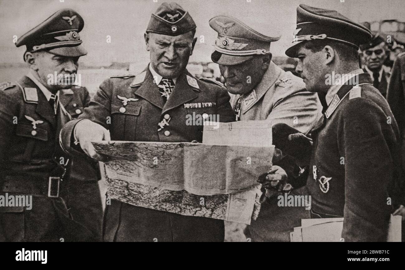 Luftwaffe Commander-in-Chief Hermann Göring in conversation with staff officers during the Battle of Britain. The Luftwaffe was officially created on 26 February 1935, with Göring as its commander-in-chief, who thought the RAF could be eliminated prior to the proposed invasion (Operation Sealion). He had been a celebrated First World War fighter pilot and was one of Hitler’s closest political associates. Stock Photo