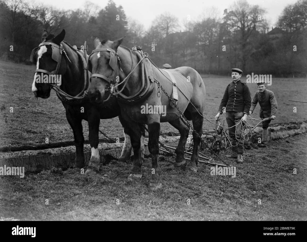 German prisoners of war work the local farmers fields near Guilford 1917 Stock Photo