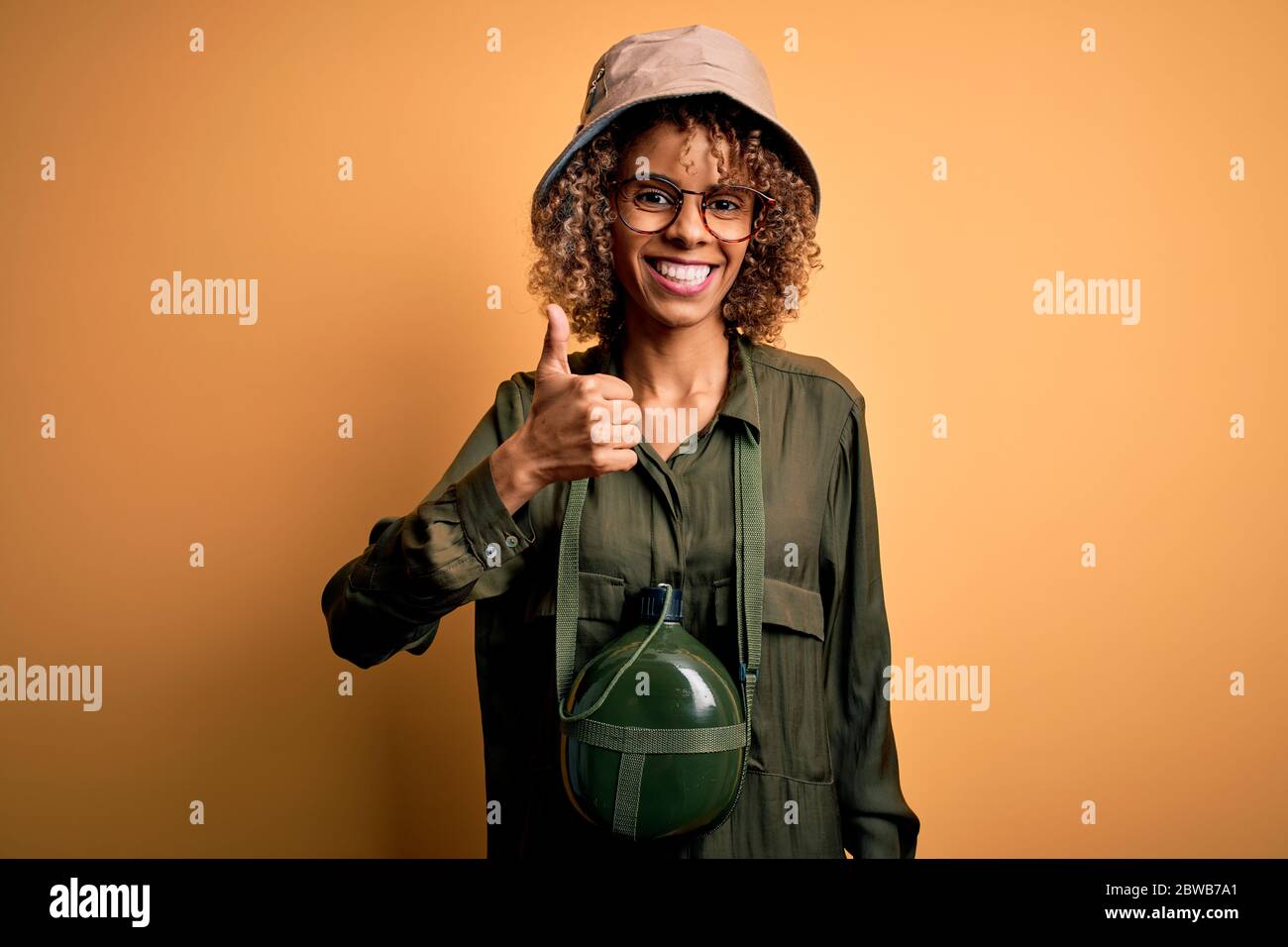 Young african american tourist woman on vacation wearing explorer hat ...