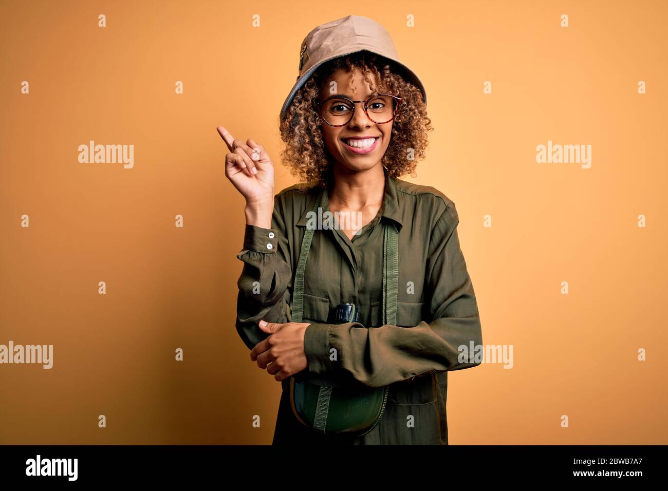 Young african american tourist woman on vacation wearing explorer hat ...
