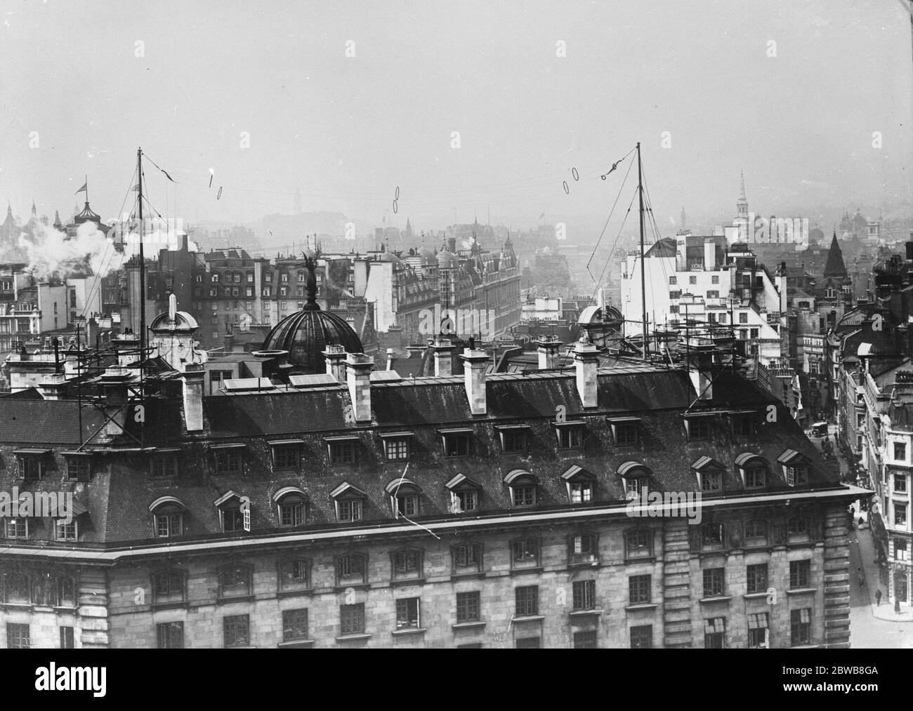 The aerials of 2 LO , the London Broadcasting Station at Marconi House , Strand . The Marconi transmitter is in the room at the top of the building on the extreme left and is connected with the studios by underground cables . Marconi 's Wireless Telegraph Co Ltd . 1 January 1925 Stock Photo