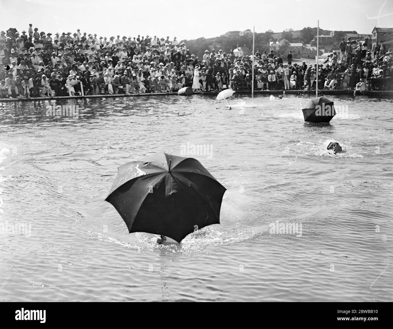 Jersey Water Gymkhana . The ' swimming with umbrella ' race . 16th August 1919 Stock Photo