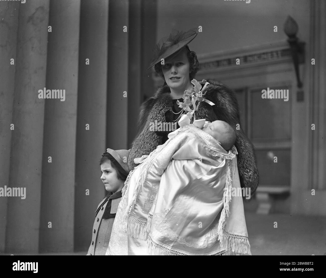 Mrs David Forbes and her infant son after the latter ' s christening at the Guards Chapel , Wellington Barracks 21st March 1938 Stock Photo