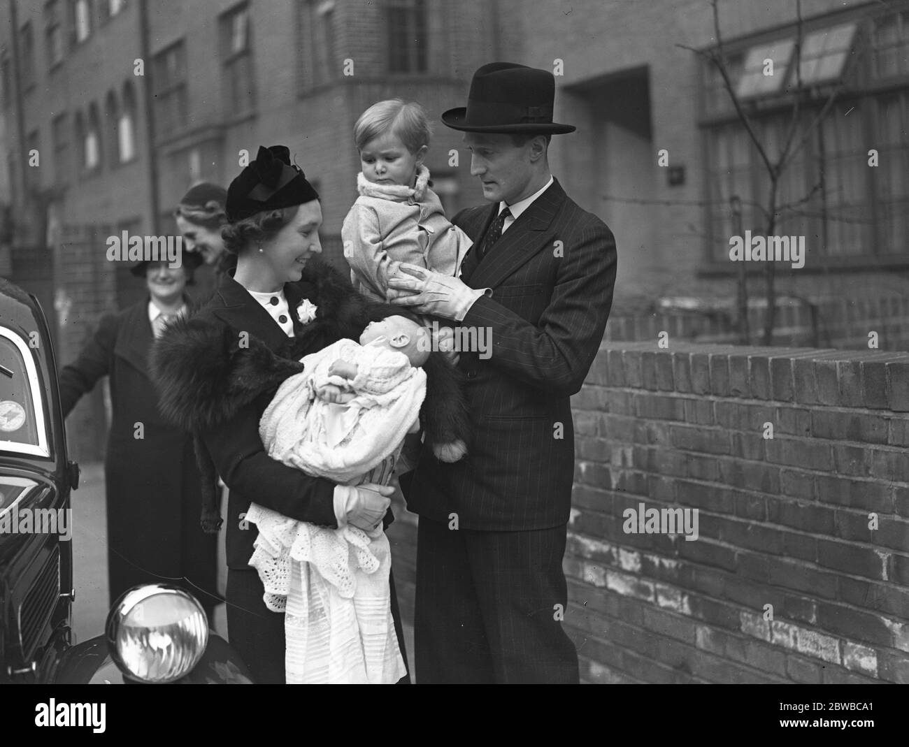 Mr and Mrs O Grazebrook , their small son Arthur and infant Roland , after the latter's christening at Chelsea Old Church 7th March 1938 Stock Photo