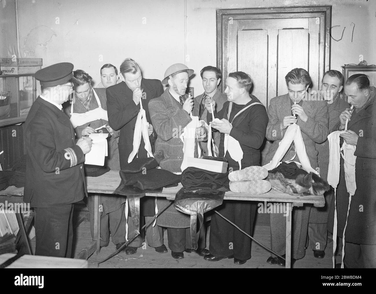 Men of the merchant navy recieving instruction in gunnery at an East London instructional battery , and drawing kit 8 January 1940 Stock Photo